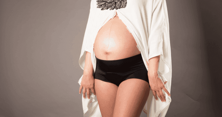 Pregnant woman in black underwear